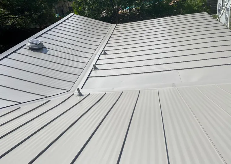 Solar attic fan installed on a metal roof for Roof Ventilation in Egg Harbor